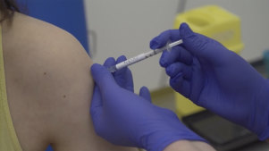 Screen grab taken from video issued by Britain's Oxford University, showing a person being injected as part of the first human trials in the UK to test a potential coronavirus vaccine, untaken by Oxford University in England.  Screen grab taken from video issued by Britain's Oxford University, showing a person being injected as part of the first human trials in the UK to test a potential coronavirus vaccine, untaken by Oxford University in England.